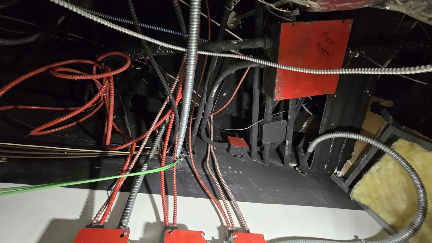 Base-building fire alarm distribution running through a tenant ceiling void
