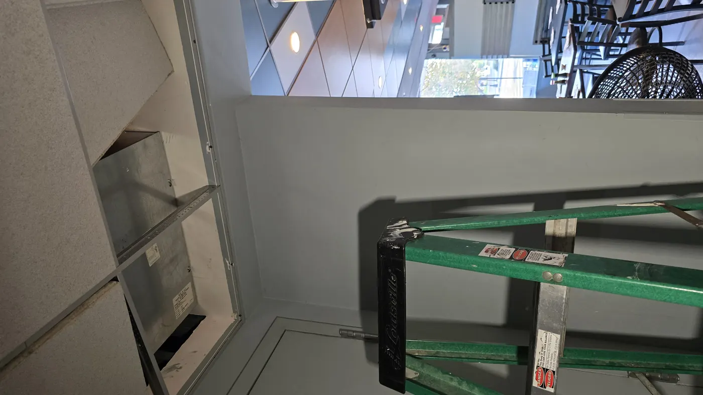 A ceiling access point opened during an existing conditions survey