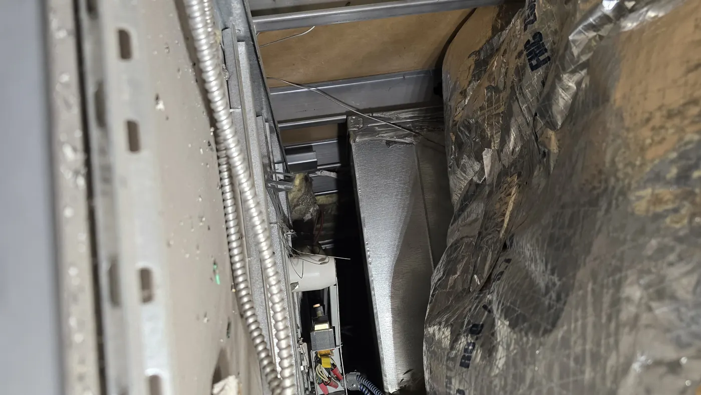 Damaged duct insulation recorded above a suspended ceiling