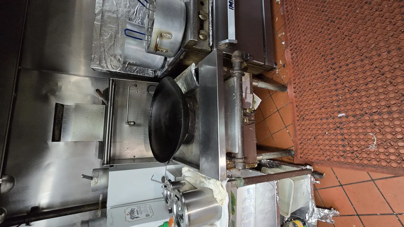 The underside of a commercial kitchen extract hood, showing filters in place