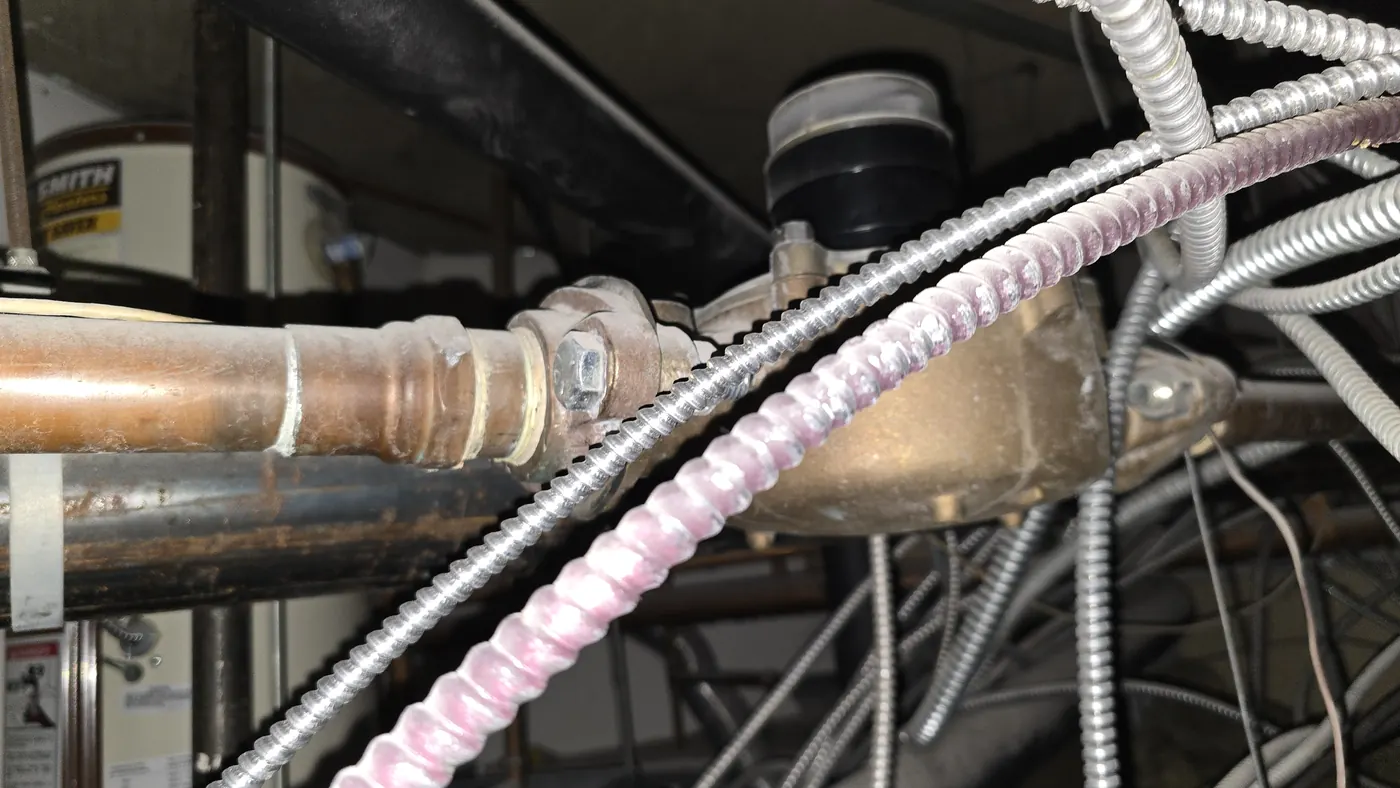 A domestic water meter located in a ceiling void outside the tenant demise
