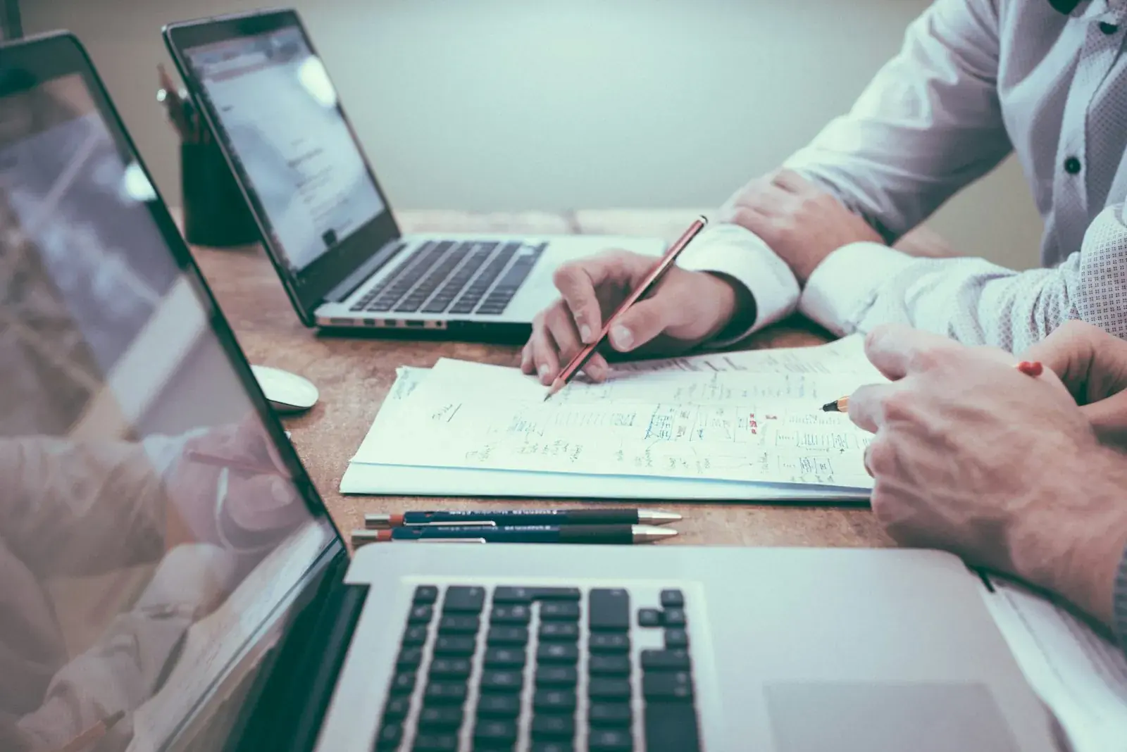 Professional reviewing documentation and project plans at a desk