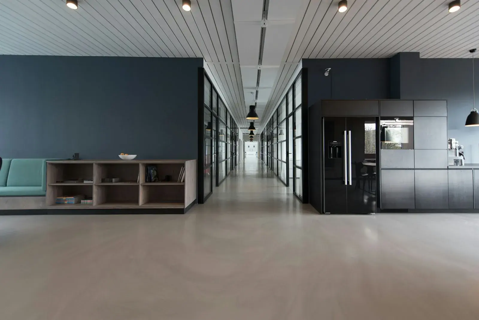 Empty commercial shell space showing exposed ceiling structure and MEP services before franchise build-out
