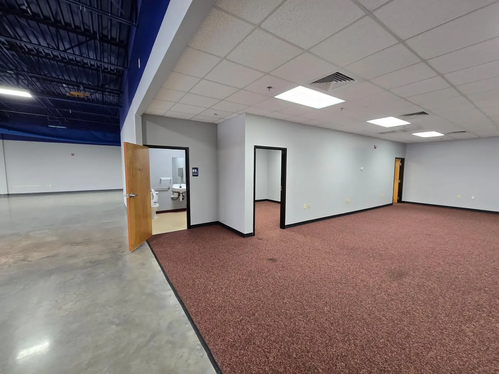 Vacant commercial suite documented before a behavioral health clinic fit-out, showing partitions, ceiling grid and existing services